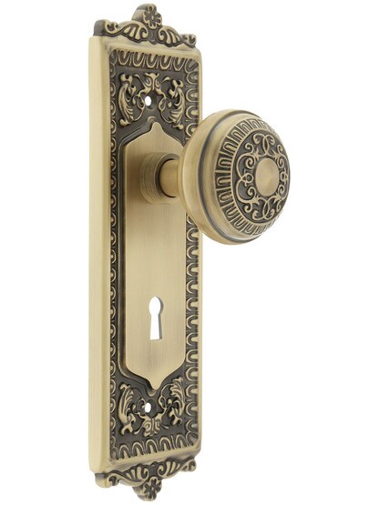 Egg and Dart Design Mortise Lock Set With Matching Knobs in Antique Brass.